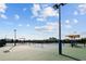 Well maintained tennis court with shade structure at 7401 Paradiso Dr, Apollo Beach, FL 33572