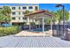 Private hot tub with a wooden deck and pergola for shade at 7434 Bayshore Dr # 404, Treasure Island, FL 33706