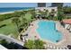 Community pool with plenty of lounge chairs at 7434 Bayshore Dr # 404, Treasure Island, FL 33706