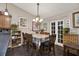 Charming dining area with a rustic table and chandelier at 7839 Knox Loop, New Port Richey, FL 34655