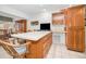 Well-equipped kitchen with wood cabinets, breakfast bar and modern appliances at 8236 Brentwood Rd, Seminole, FL 33777