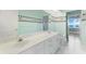 Bright bathroom with double sinks,water closet and a shower at 843 Harbor Is, Clearwater Beach, FL 33767