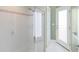 Clean bathroom with a glass shower door and white tiled walls at 843 Harbor Is, Clearwater Beach, FL 33767