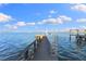 Wooden dock extending over calm water, offering scenic waterfront views at 843 Harbor Is, Clearwater Beach, FL 33767