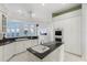 White kitchen with granite island and water views at 843 Harbor Is, Clearwater Beach, FL 33767