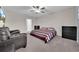 Spacious bedroom with striped bedding and a comfortable couch at 9512 Lemon Drop Loop, Ruskin, FL 33573
