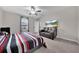 Bright bedroom featuring a large bed, couch and window at 9512 Lemon Drop Loop, Ruskin, FL 33573