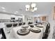 Dining room with a table set for six and chandelier at 9512 Lemon Drop Loop, Ruskin, FL 33573