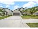 Two-story house with a two-car garage and landscaped lawn at 9512 Lemon Drop Loop, Ruskin, FL 33573