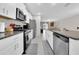 Modern kitchen with white cabinets and stainless steel appliances at 9512 Lemon Drop Loop, Ruskin, FL 33573