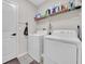 Convenient laundry room with washer, dryer, and shelving at 9512 Lemon Drop Loop, Ruskin, FL 33573