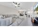 Open living area with sectional sofa and a large TV at 9512 Lemon Drop Loop, Ruskin, FL 33573