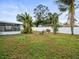 Spacious backyard with lush landscaping and a relaxing seating area at 9909 48Th N Ave, St Petersburg, FL 33708