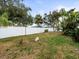 Simple backyard with a grassy area and white fence at 9909 48Th N Ave, St Petersburg, FL 33708