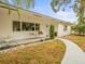 White single story home with porch swing and landscaped yard at 9909 48Th N Ave, St Petersburg, FL 33708