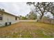 Backyard with large grassy area and partial fence at 10107 N Arden Ave, Tampa, FL 33612