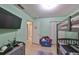 bedroom with bunk bed, TV, and ample closet space at 10107 N Arden Ave, Tampa, FL 33612