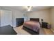 Spacious bedroom with a double bed, dresser, and ensuite bathroom at 10107 N Arden Ave, Tampa, FL 33612