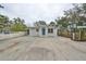 House exterior, gray with blue door, ample parking and basketball hoop at 10107 N Arden Ave, Tampa, FL 33612