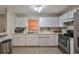 White kitchen cabinets, stainless steel appliances, and microwave at 10107 N Arden Ave, Tampa, FL 33612