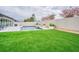 Landscaped backyard featuring artificial turf and privacy fence at 10832 Sage Canyon Dr, Riverview, FL 33578