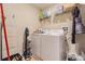 Laundry room with washer, dryer, and ample storage shelving at 10832 Sage Canyon Dr, Riverview, FL 33578