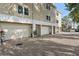 Rear view of townhomes with attached garages and paved parking at 1109 Pinellas Bayway S # 403, Tierra Verde, FL 33715