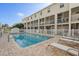 Community pool with lounge chairs and surrounding patio at 1109 Pinellas Bayway S # 403, Tierra Verde, FL 33715