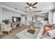 Bright living room with light colored couch and wood-look floors at 11310 Palm Island Ave, Riverview, FL 33569