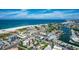 Aerial view of a coastal town with beach, waterway, and residential buildings at 11605 Gulf Blvd # 302, Treasure Island, FL 33706