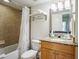 Bathroom featuring a shower/tub combo and granite countertop at 11605 Gulf Blvd # 302, Treasure Island, FL 33706