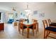 Dining area with glass table, wooden chairs, and a modern chandelier at 11605 Gulf Blvd # 302, Treasure Island, FL 33706