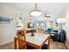 Dining area with glass table, wooden chairs, and a view into the bedroom at 11605 Gulf Blvd # 302, Treasure Island, FL 33706