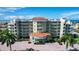 Exterior of a multi-story building with parking and palm trees at 11605 Gulf Blvd # 302, Treasure Island, FL 33706