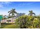 Building exterior view showcasing a multi-story building with palm trees at 11605 Gulf Blvd # 302, Treasure Island, FL 33706