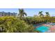 Resort-style pool and deck area with lounge chairs and palm trees at 11605 Gulf Blvd # 302, Treasure Island, FL 33706