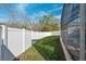 Landscaped backyard with a large white vinyl fence at 12509 Bay Branch Ct, Tampa, FL 33635