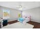 Bedroom with wood floors and pink headboard at 12509 Bay Branch Ct, Tampa, FL 33635