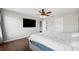 Bright bedroom with wood floors and a large TV at 12509 Bay Branch Ct, Tampa, FL 33635