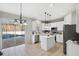 Modern kitchen with white cabinets, island, and pool view at 12509 Bay Branch Ct, Tampa, FL 33635