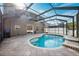 Enjoy this kidney-shaped pool with screened enclosure and waterfall feature at 12509 Bay Branch Ct, Tampa, FL 33635