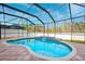 Escape to this refreshing kidney-shaped pool with a screened enclosure and waterfall at 12509 Bay Branch Ct, Tampa, FL 33635