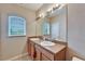 Double sink bathroom with large mirror and window at 12610 Geneva Glade Dr, Riverview, FL 33578