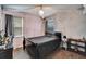 Bedroom with canopy bed and dark wood floors at 12610 Geneva Glade Dr, Riverview, FL 33578