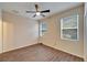 Bright bedroom with wood-look tile floors and ceiling fan at 12610 Geneva Glade Dr, Riverview, FL 33578