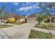 Two-story house with attached garage and driveway, next to a yellow van at 12610 Geneva Glade Dr, Riverview, FL 33578