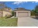 Two-story house with a two-car garage and nicely landscaped front yard at 12610 Geneva Glade Dr, Riverview, FL 33578