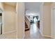 Hallway with stairs leading upstairs and views of the kitchen and dining area at 12610 Geneva Glade Dr, Riverview, FL 33578