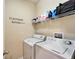 Laundry room with washer, dryer, and shelving at 12610 Geneva Glade Dr, Riverview, FL 33578