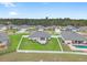 Aerial view showcasing a home's backyard oasis with a patio and lush lawn at 13008 Weatherstone Dr, Spring Hill, FL 34609